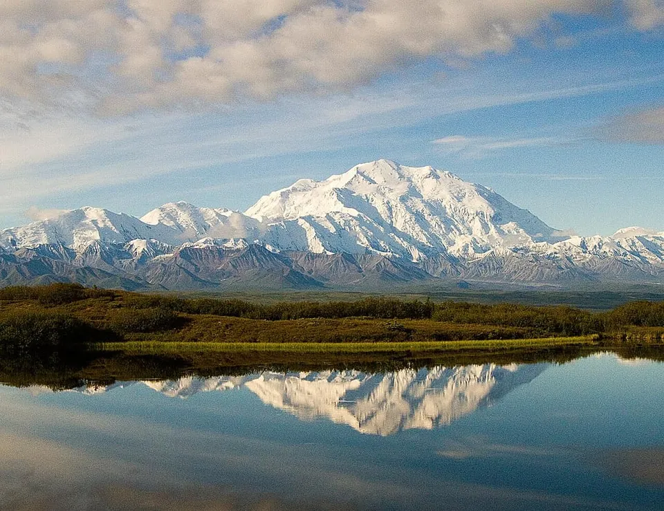 Snow-covered Denali massif reflected across Wonder Lake, Alaska